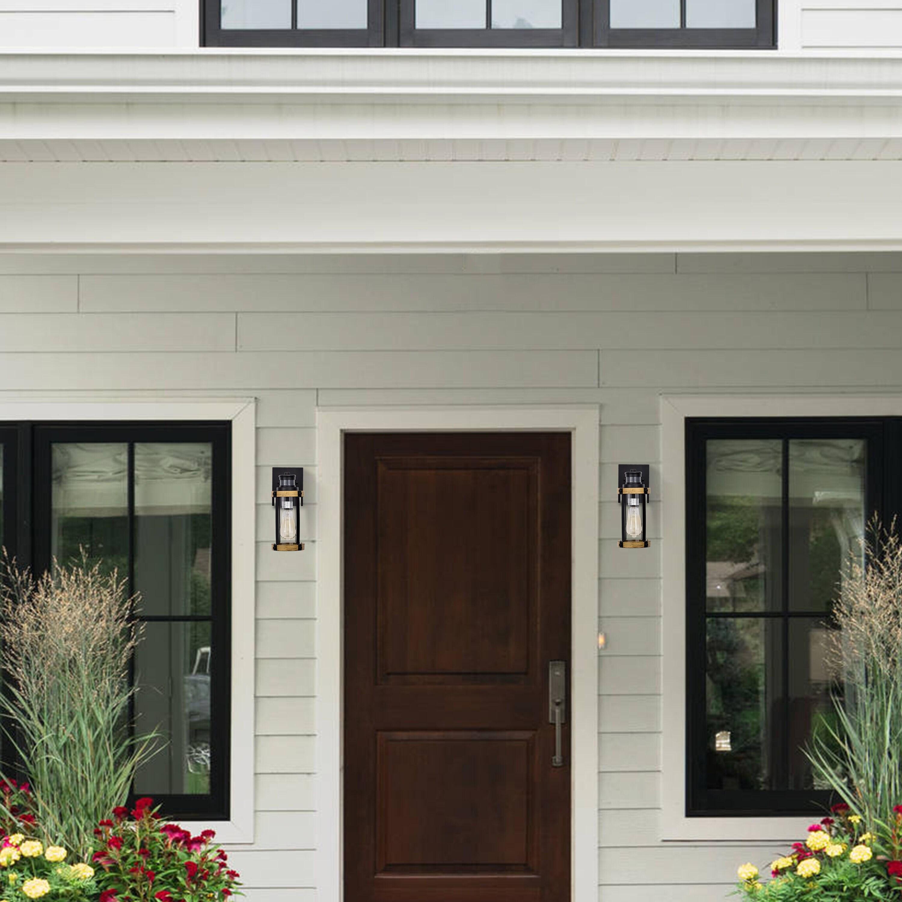 C Cattleya 5.5 in. 1-Light Motion Sensing Dusk to Dawn Outdoor Wall Sconce Black and Woodgrain Finish with Striped Clear Glass