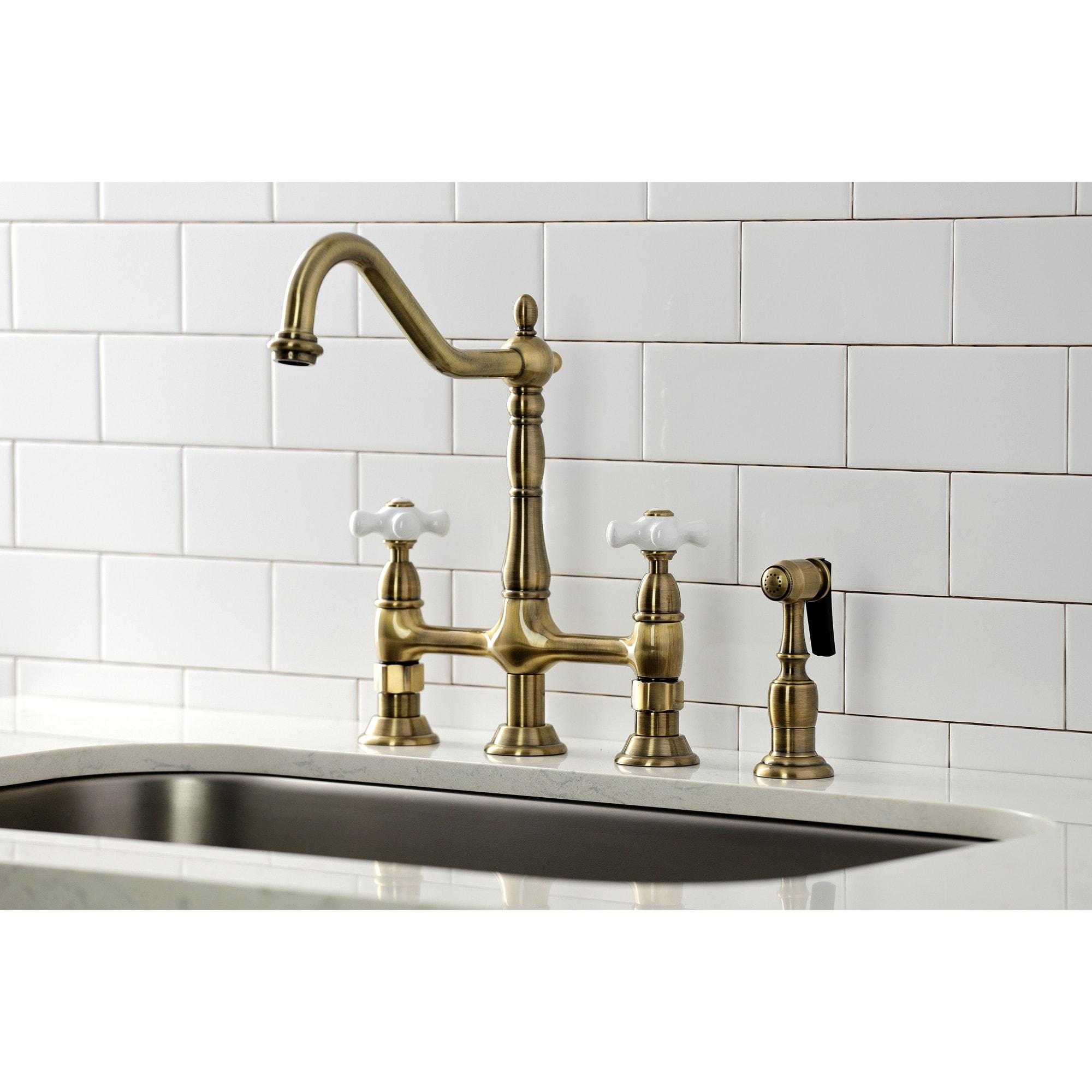 Kingston Brass Heritage Two-Handle 4-Hole Deck Mount Bridge Kitchen Faucet with Brass Side Sprayer
