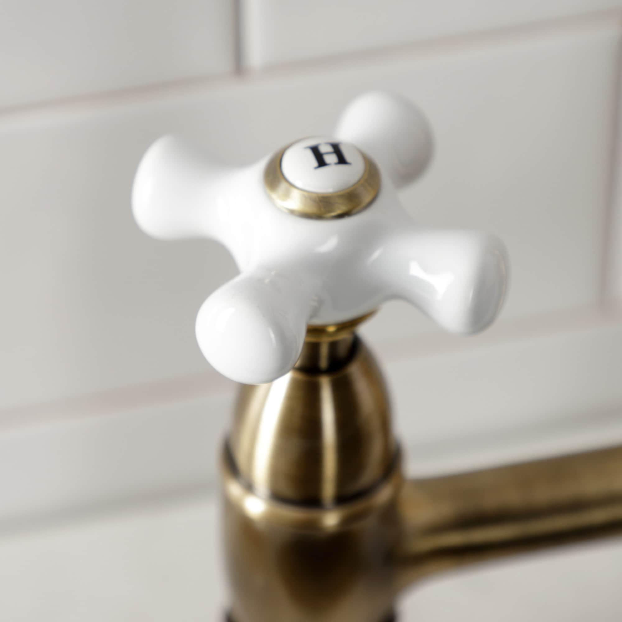 Kingston Brass Heritage Two-Handle 4-Hole Deck Mount Bridge Kitchen Faucet with Brass Side Sprayer