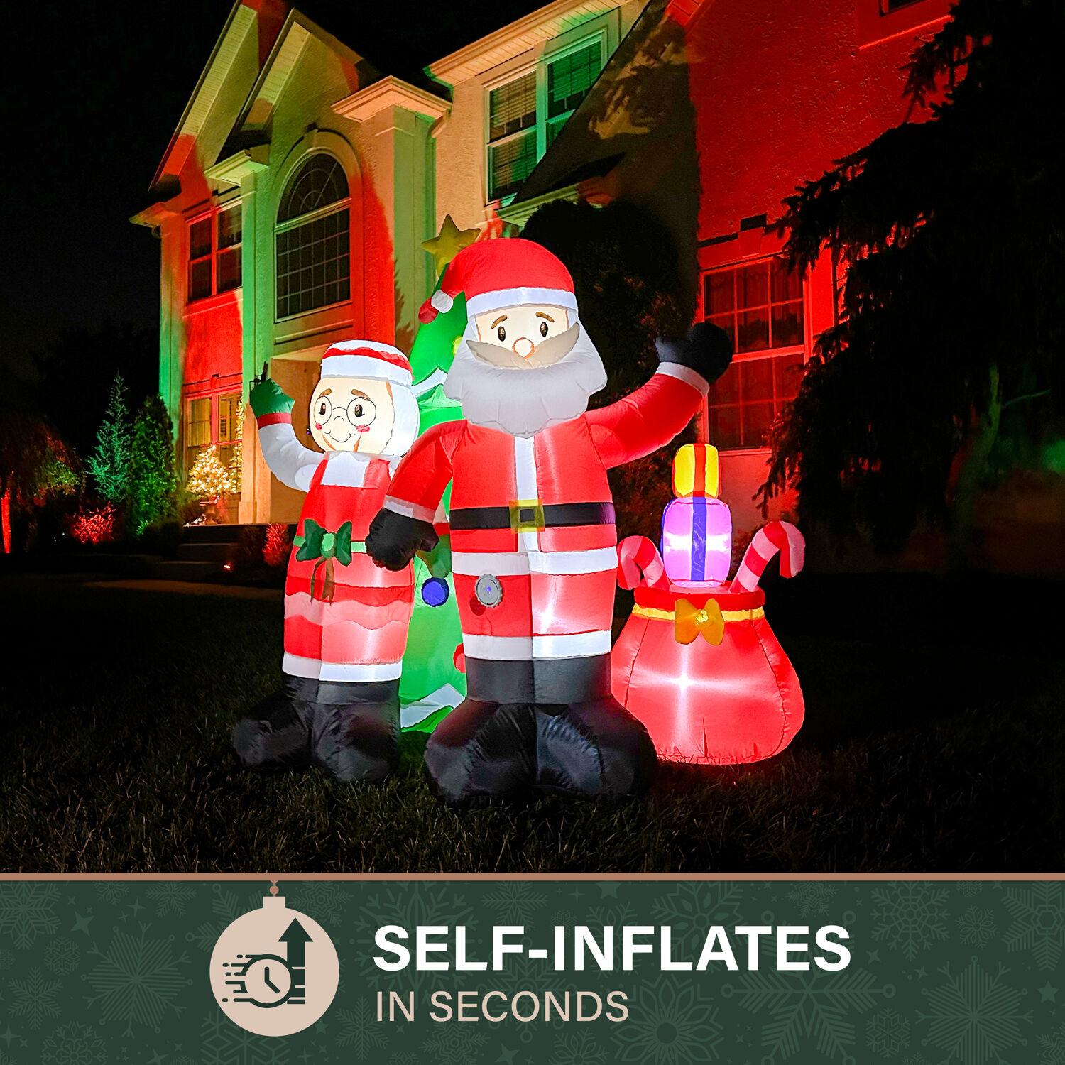 Fraser Hill Farm 6-Ft. Tall Prelit Mr. and Mrs. Claus with Tree Inflatable with Music
