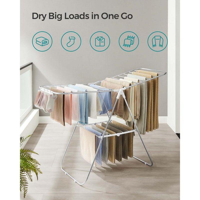 SONGMICS Foldable Clothes Drying Rack with Sock Clips Laundry Drying Rack with Height-Adjustable Gullwings