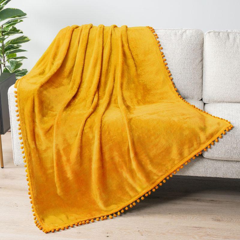 PAVILIA Fleece Pom Pom Blanket Throw for Sofa Bed, Soft Lightweight Pompom Fringe Blanket for Couch