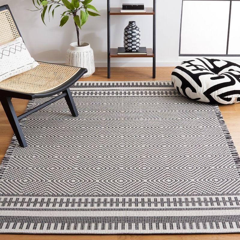 Augustine Geometric Black and Ivory 5' x 7' Synthetic Area Rug