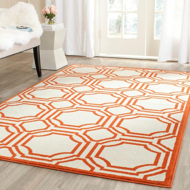 Ivory and Orange Geometric 8' x 10' Stain-Resistant Synthetic Rug