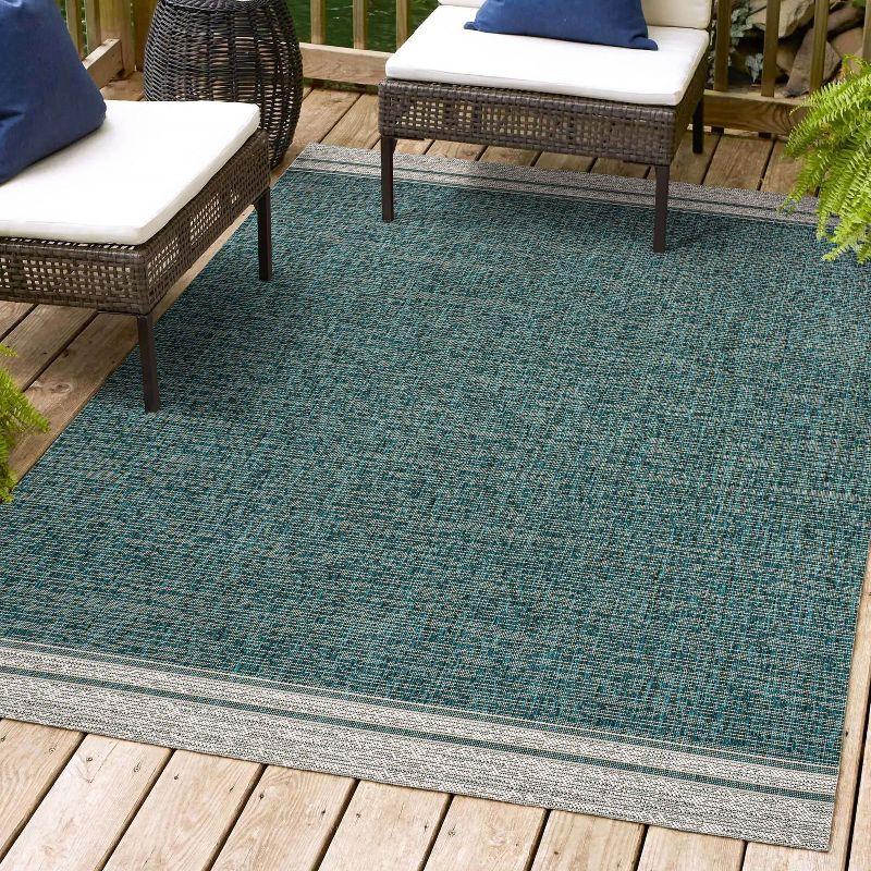 Turquoise and Cream 4' x 6' Solid Synthetic Area Rug