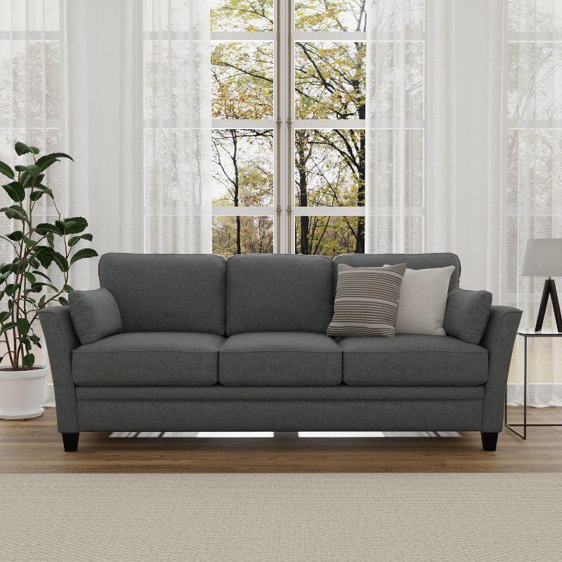 Gray Upholstered Sofa with Flared Arms and Pillows