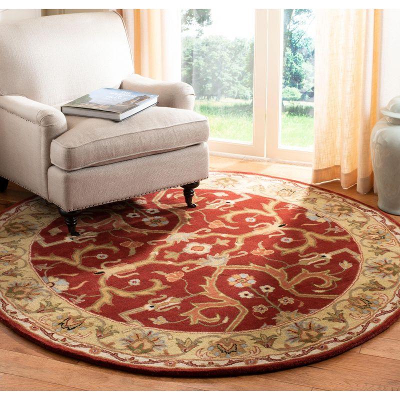 Elegant Heritage 6' Round Red and Gold Hand-Tufted Wool Rug