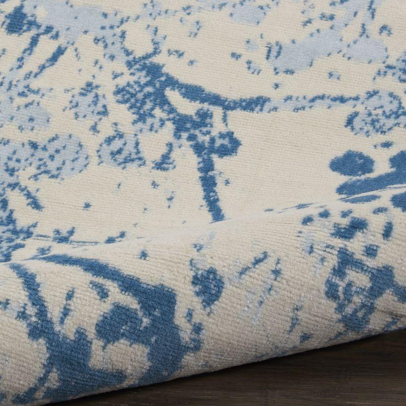 Ivory and Blue Abstract Synthetic 2' x 4' Easy-Care Area Rug