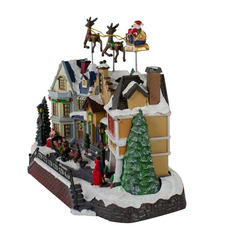Northlight Seasonal 16" White and Brown LED Lighted and Animated Christmas Village with Flying Sleigh Tabletop Decor