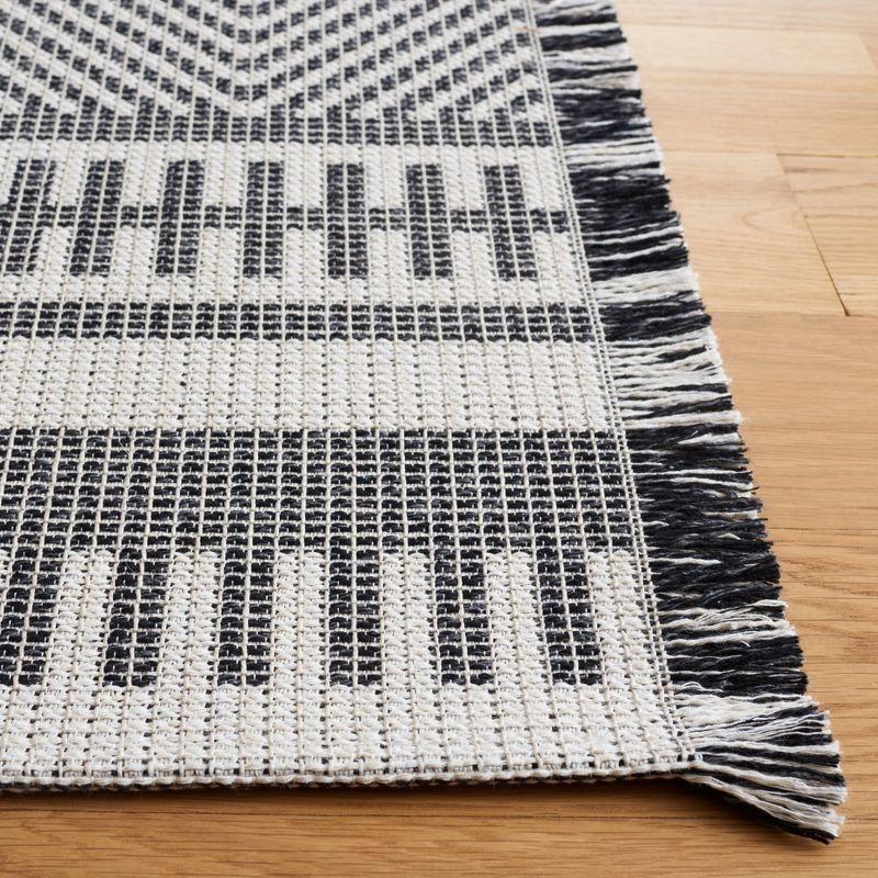 Augustine Geometric Black and Ivory 5' x 7' Synthetic Area Rug