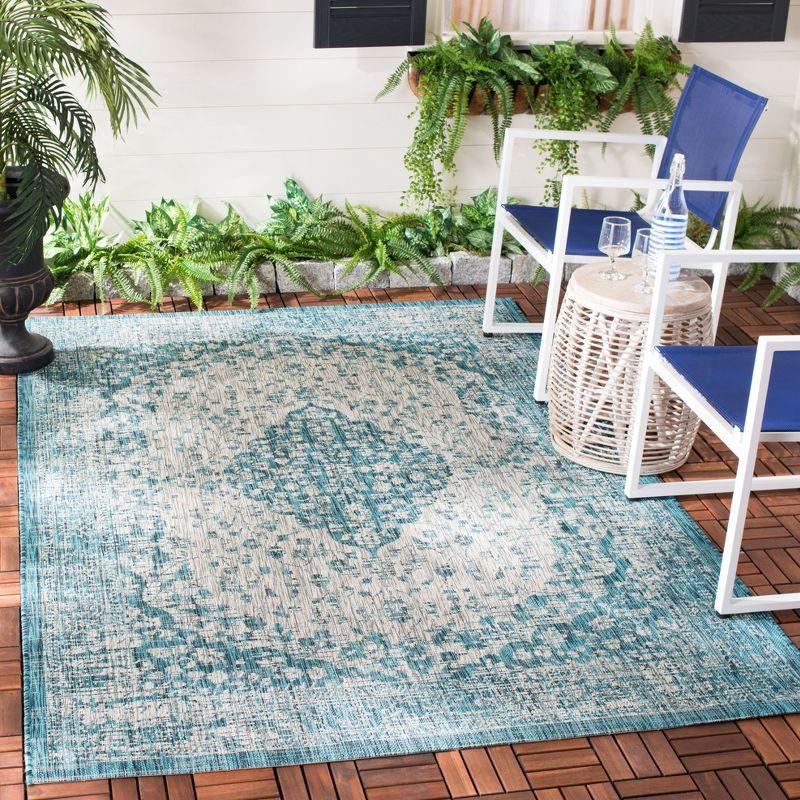 Teal and Cream Synthetic Indoor/Outdoor Area Rug