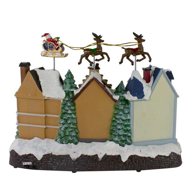 Northlight Seasonal 16" White and Brown LED Lighted and Animated Christmas Village with Flying Sleigh Tabletop Decor
