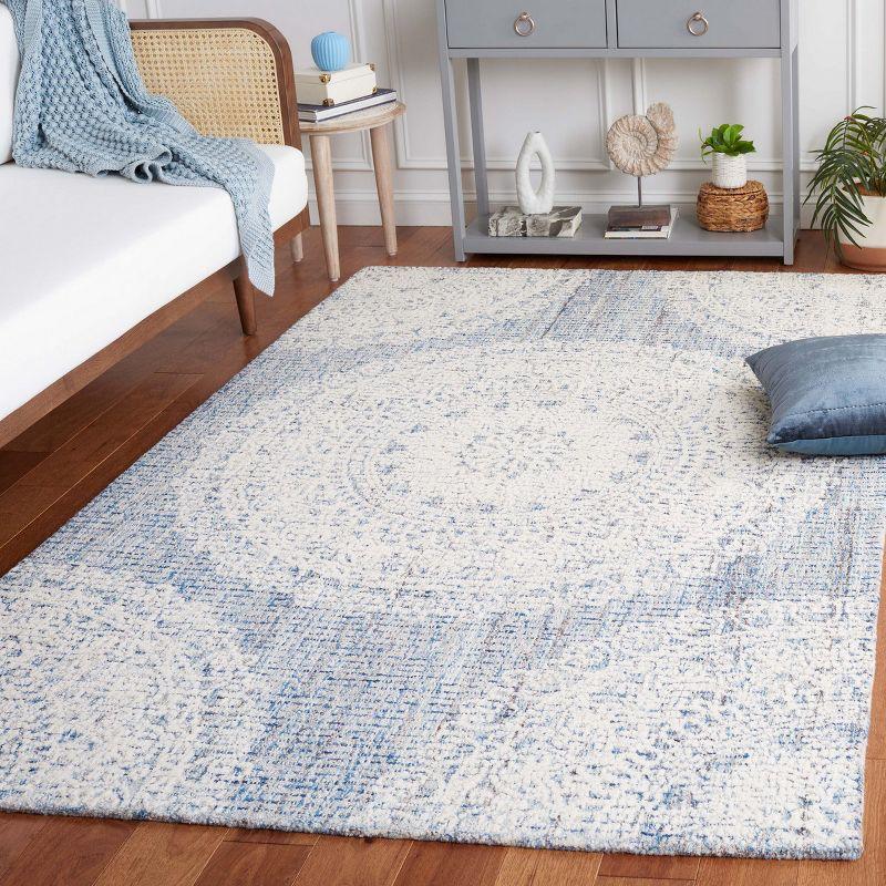 Blue and Ivory Hand Tufted Wool Area Rug 5' x 8'