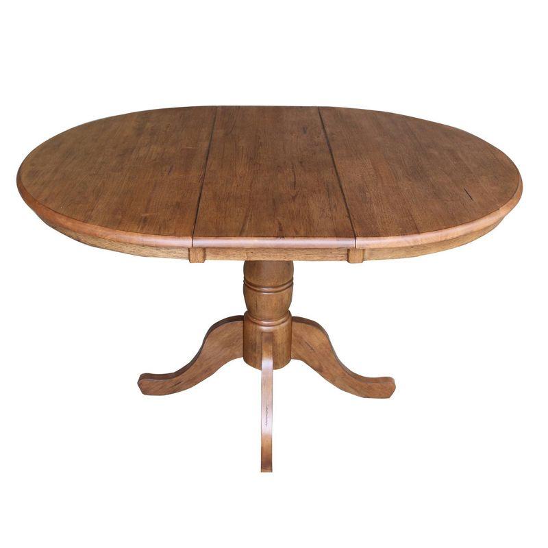 Keanan Round Top Pedestal Table with 12" Drop Leaf Distressed Oak - International Concepts