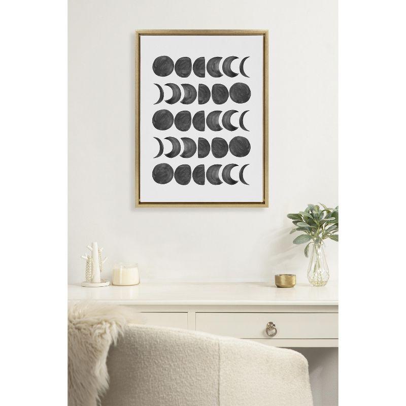 Kate and Laurel Sylvie 901 Moon Phases Black on White Framed Canvas by Teju Reval of SnazzyHues