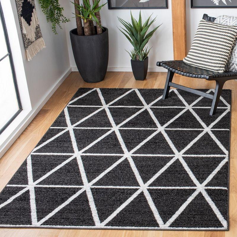 Black and Ivory Geometric Synthetic Area Rug