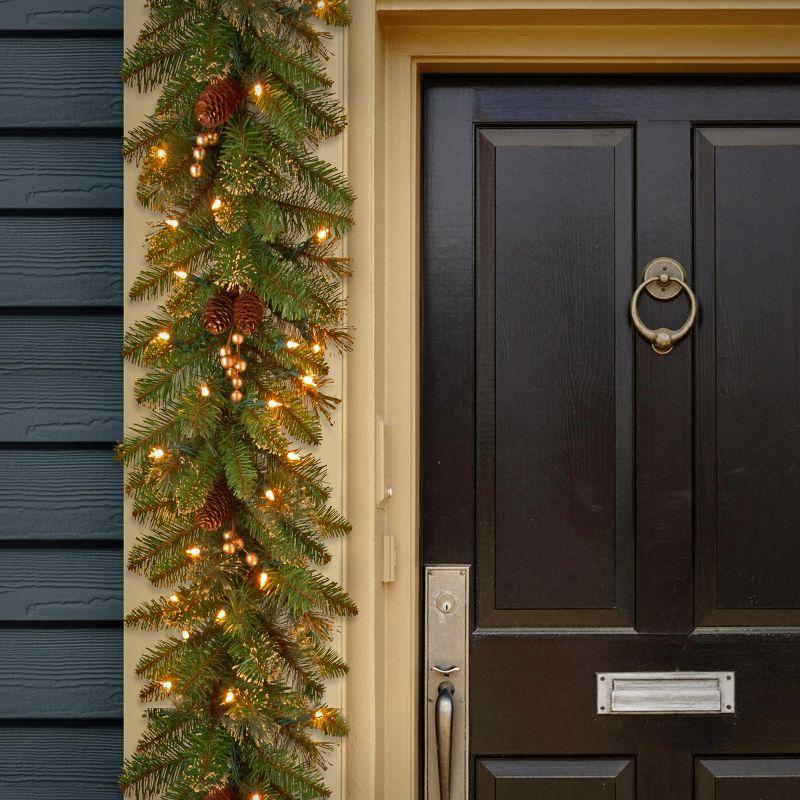 The Holiday Aisle® 9ft. Glittery Gold Pine Garland with Clear Lights