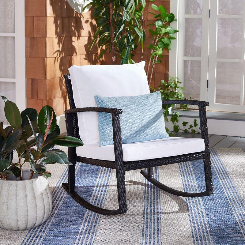 Breezy Black PE Rattan Rocking Chair with Plush White Cushions