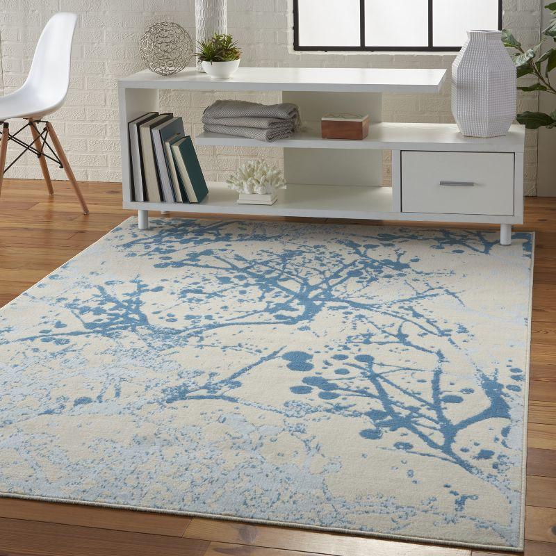 Ivory and Blue Abstract Synthetic 2' x 4' Easy-Care Area Rug