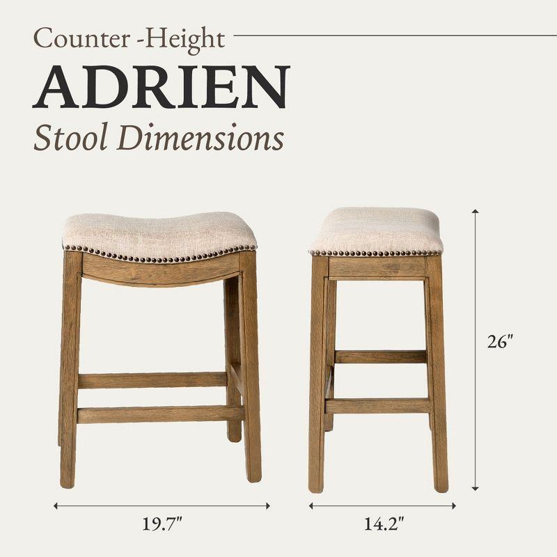 Maven Lane Adrien 26 Inch Counter Height Upholstered Backless Saddle Barstool in Natural Wood Finish with Wheat Cream Fabric Cushion Seat, Set of 3