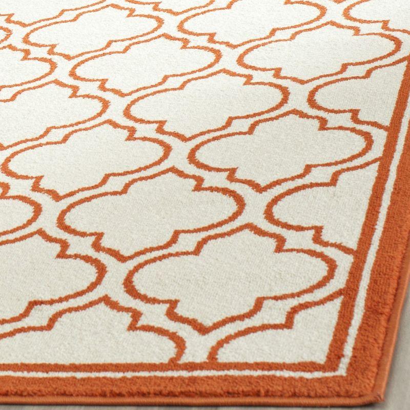 Ivory and Orange Geometric Low Pile Area Rug