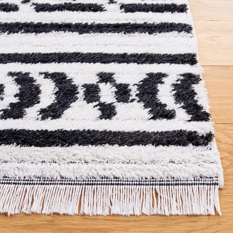 Nomadic Boho-Mod Black & Ivory Synthetic Area Rug - 6'4" x 9'6"