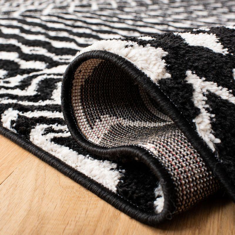 Boho-Chic Black and Ivory Moroccan-Inspired 2' x 5' Synthetic Area Rug