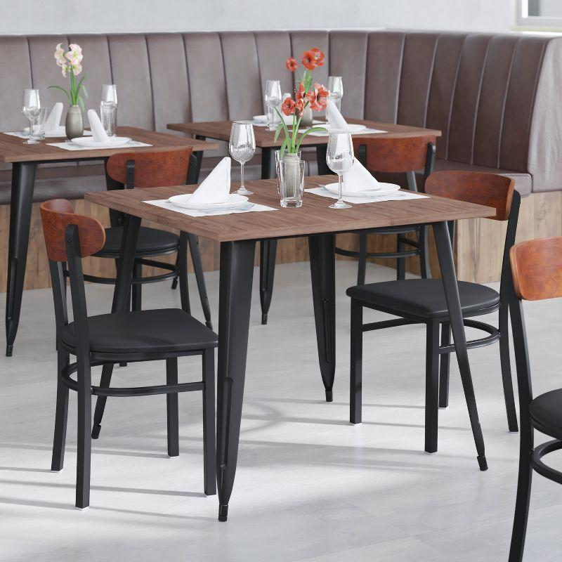 Flash Furniture Wright Commercial Dining Chair with 500 LB. Capacity Black Steel Frame, Walnut Finish Wooden Boomerang Back, and Black Vinyl Seat