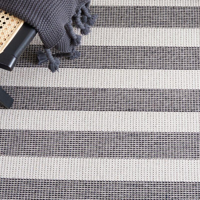 Augustine Black and Ivory Stripe 5' x 7'7" Synthetic Area Rug