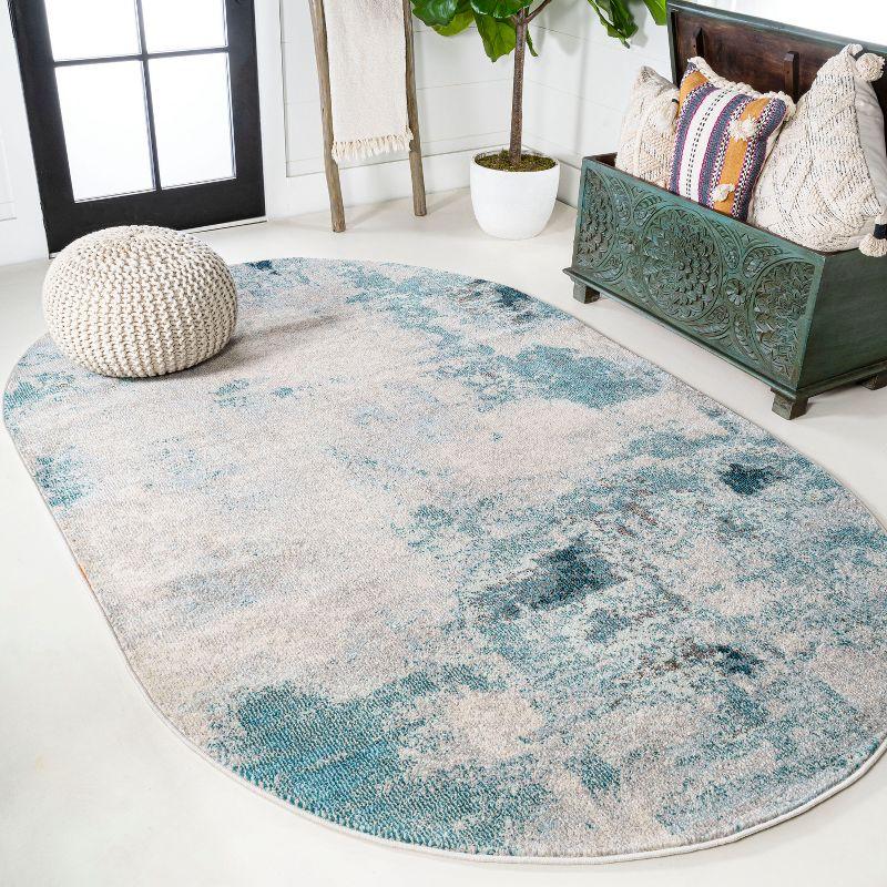 Cream and Blue Abstract Oval Synthetic Area Rug