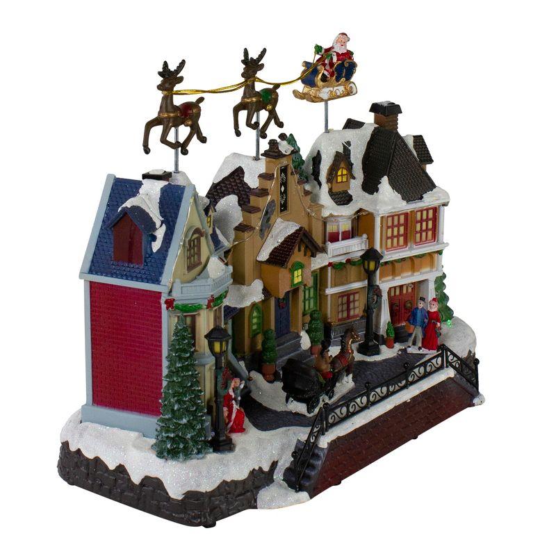 Northlight Seasonal 16" White and Brown LED Lighted and Animated Christmas Village with Flying Sleigh Tabletop Decor