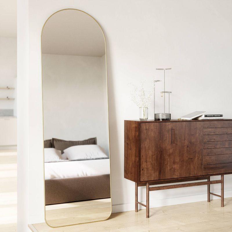 Elegant Arch Brass Leaning Floor Mirror with Sleek Metallic Rim