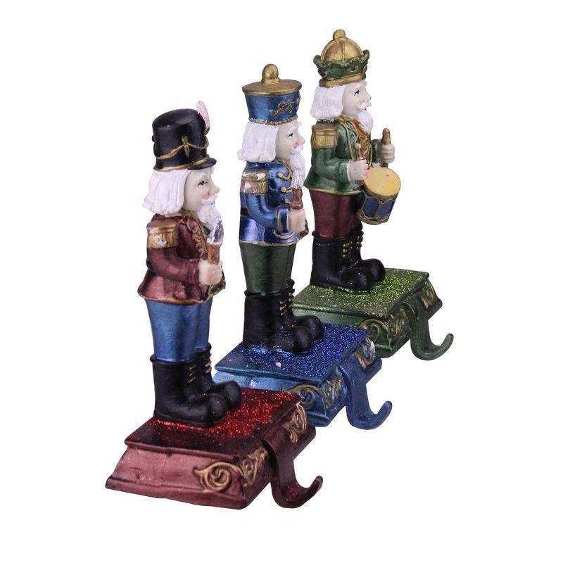 Northlight Glittered Nutcracker Stocking Holders - 7.75" - Blue, Red and Green - Set of 3