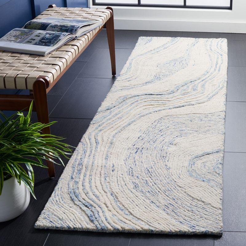 Handmade Tufted Blue and Ivory Wool Abstract Rug