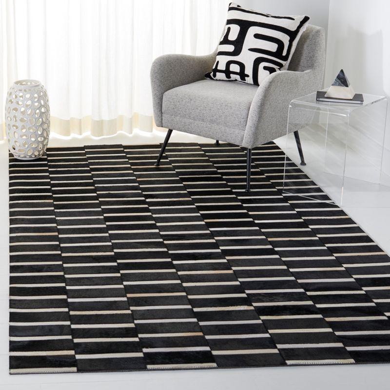 Handmade Black and Beige Geometric Cowhide Area Rug