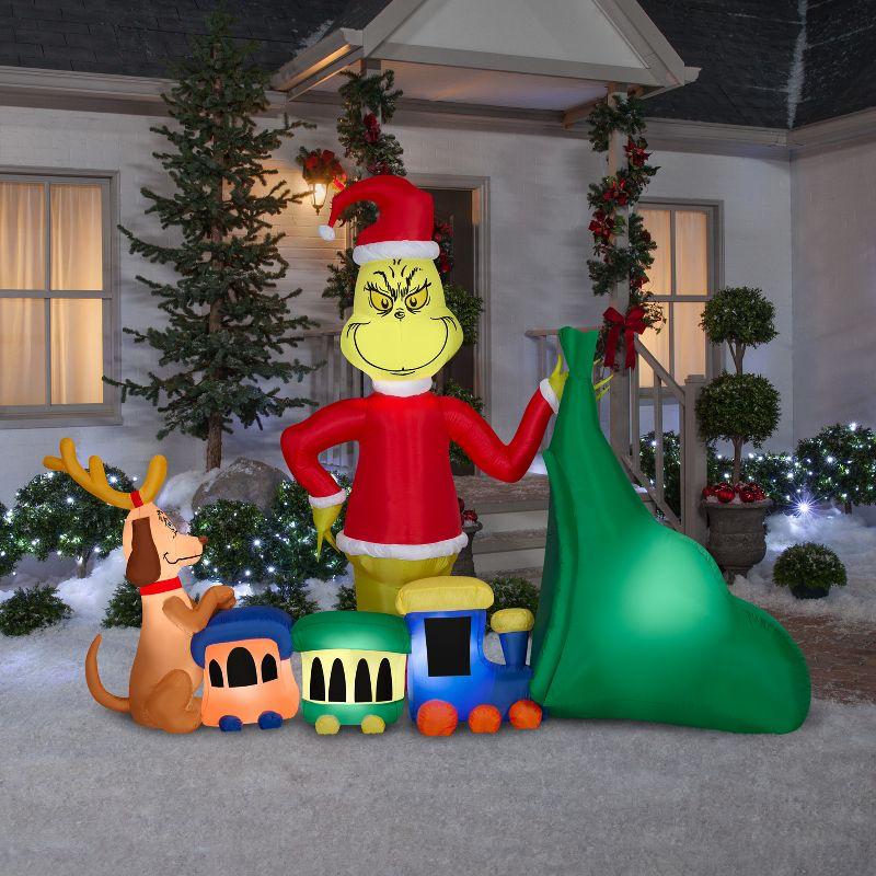 Grinch and Max Christmas Inflatable with Train and Santa Sack