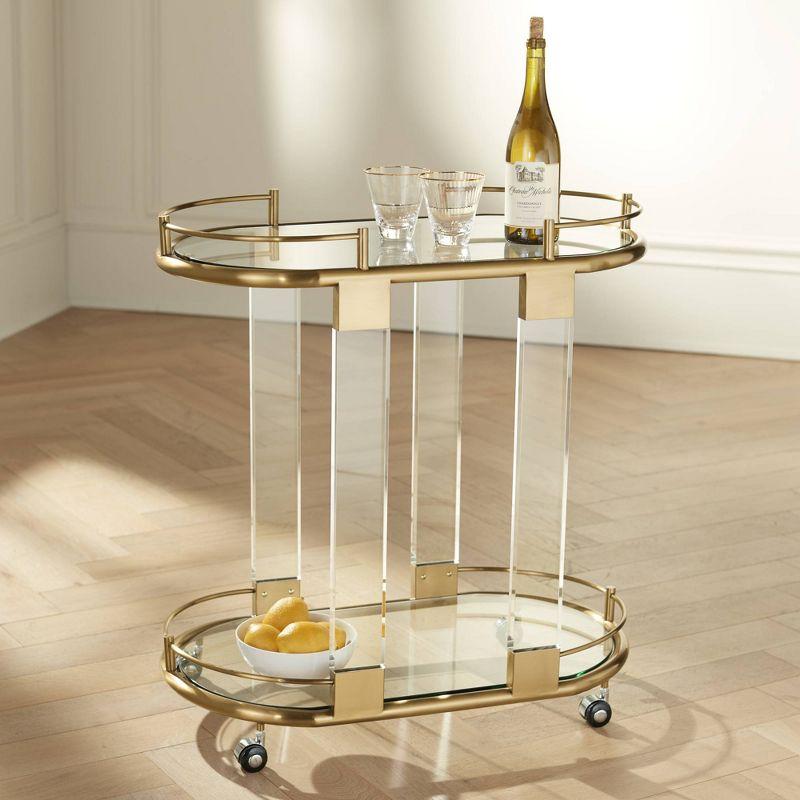 55 Downing Street Adaline 29 1/2" Wide Clear Acrylic and Gold Oval Bar Cart