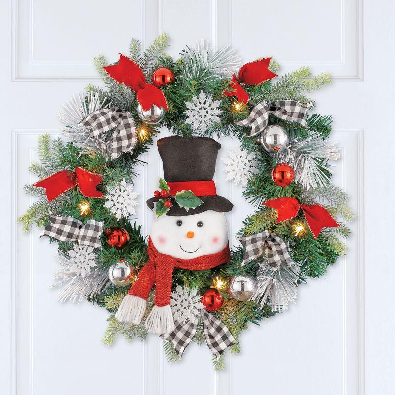 Collections Etc LED Lighted Winter Snowman Wreath with Black/White Buffalo Check Bows Green