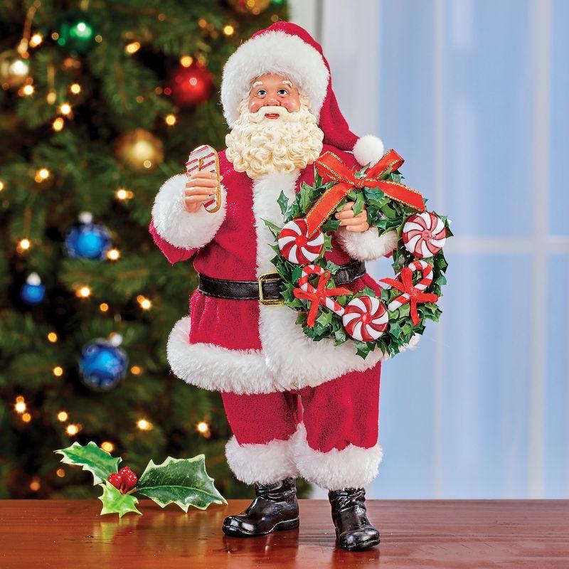 Festive Santa Claus Figurine with Candy Cane and Wreath