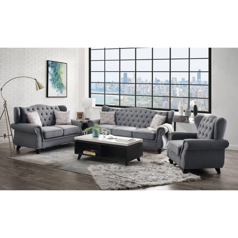 Gray Fabric Camelback Sofa with Floral Cushions and Nailhead Trim