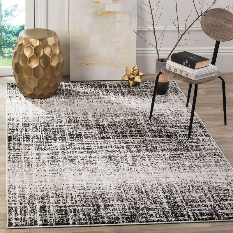 Ivory and Black Abstract Square Synthetic Accent Rug 4'x4'