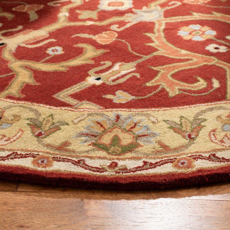 Elegant Heritage 6' Round Red and Gold Hand-Tufted Wool Rug