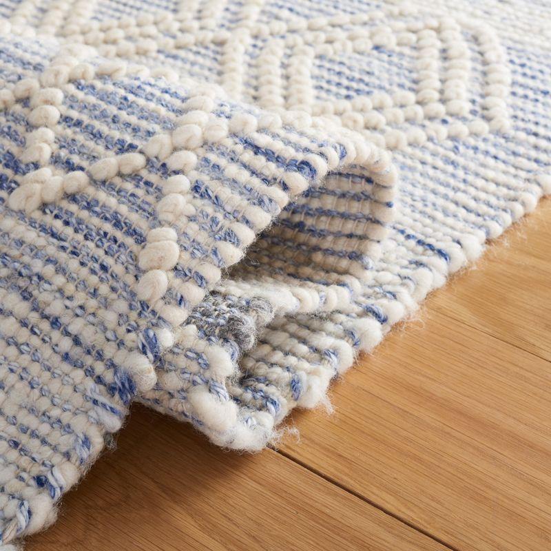 Ivory and Blue Handwoven Wool Area Rug with Fringe