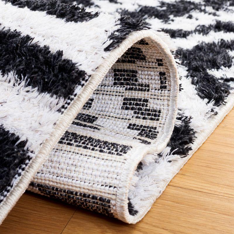 Nomadic Boho-Mod Black & Ivory Synthetic Area Rug - 6'4" x 9'6"