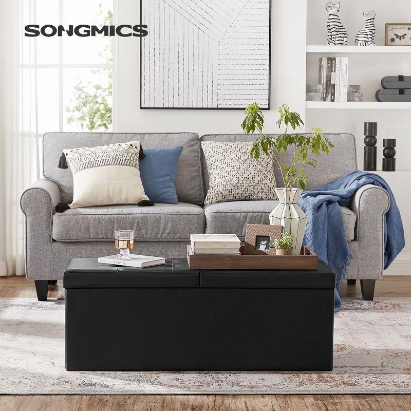 SONGMICS 43" Folding Storage Ottoman Bench Leather Ottoman Storage Footrest Hold up to 660lb Black