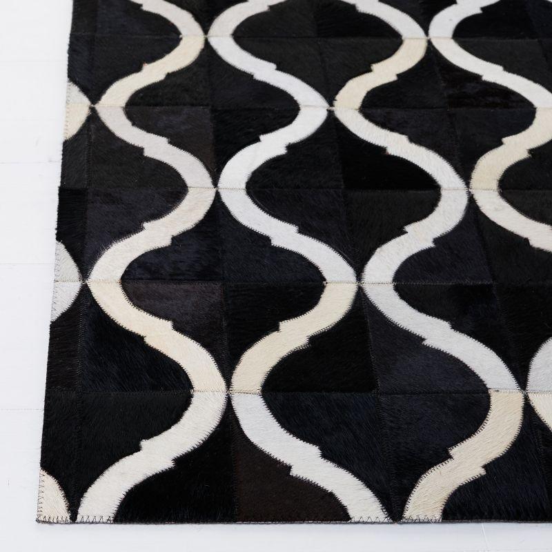 Handmade Black and Beige Geometric Cowhide Area Rug