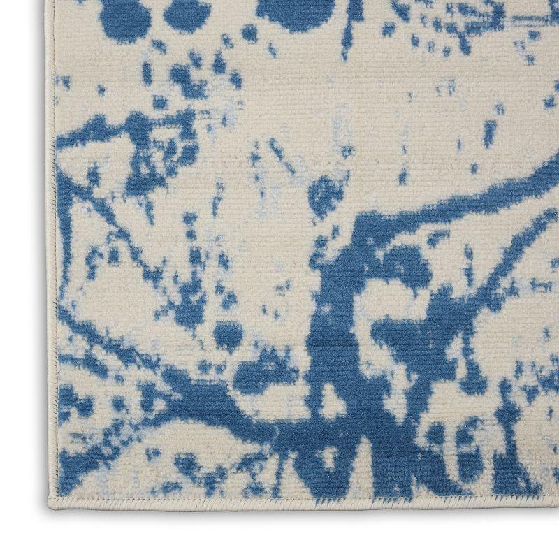 Ivory and Blue Abstract Synthetic 2' x 4' Easy-Care Area Rug