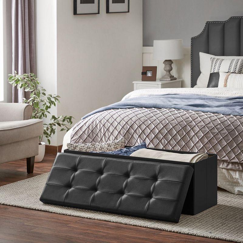 SONGMICS 43" Folding Storage Ottoman Bench Leather Ottoman Storage Footrest Hold up to 660lb Black
