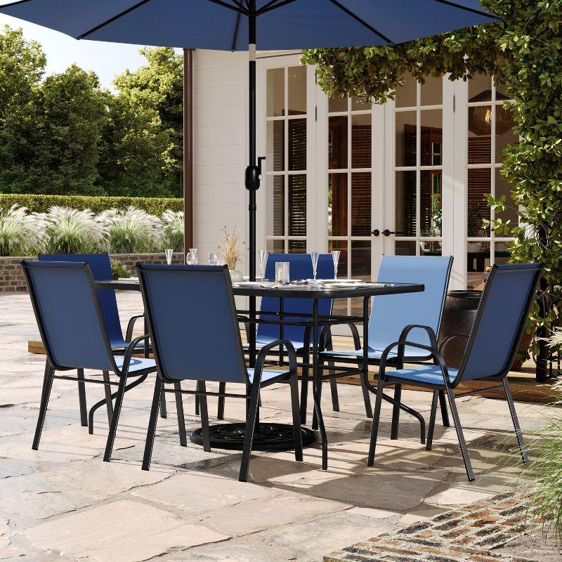 Flash Furniture Brazos 7 Piece Outdoor Patio Dining Set - 55" Tempered Glass Patio Table with Umbrella Hole, 6 Navy Flex Comfort Stack Chairs