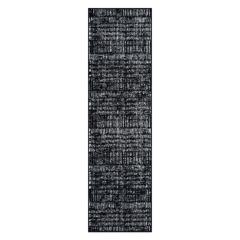 Black and Ivory Geometric Polypropylene Area Rug 2' x 7'